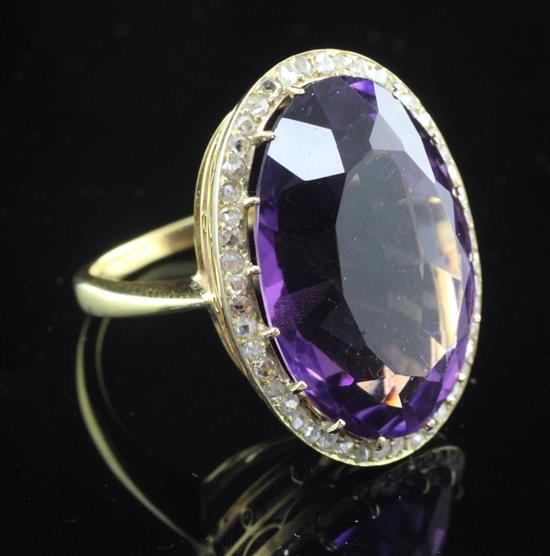 An 18ct gold, amethyst and diamond oval dress ring, size P.